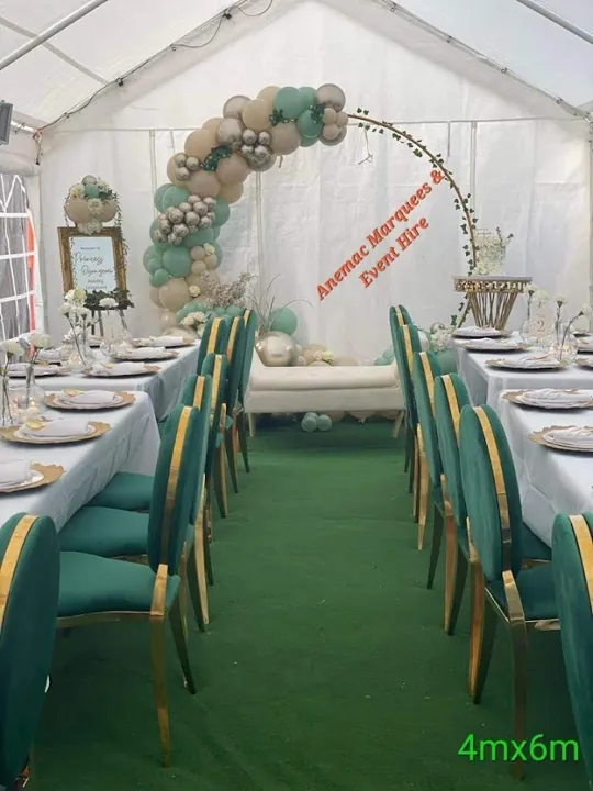 Pastel balloon arch and dressed dining tables