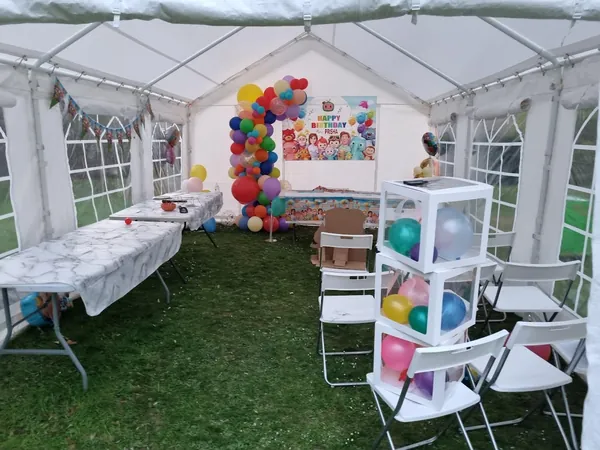 Garden party marquee with balloons and tables