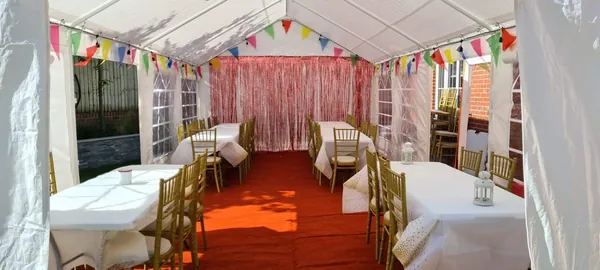 Garden marquee with bunting and long tables